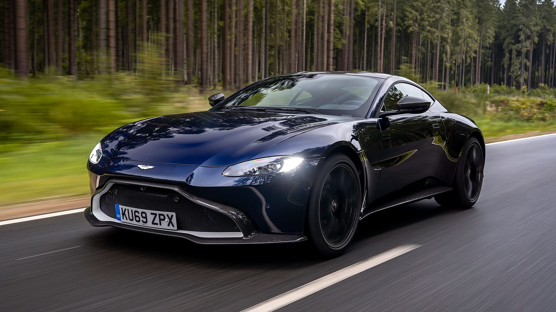 Aston Martin Vantage dark blue on forest road
