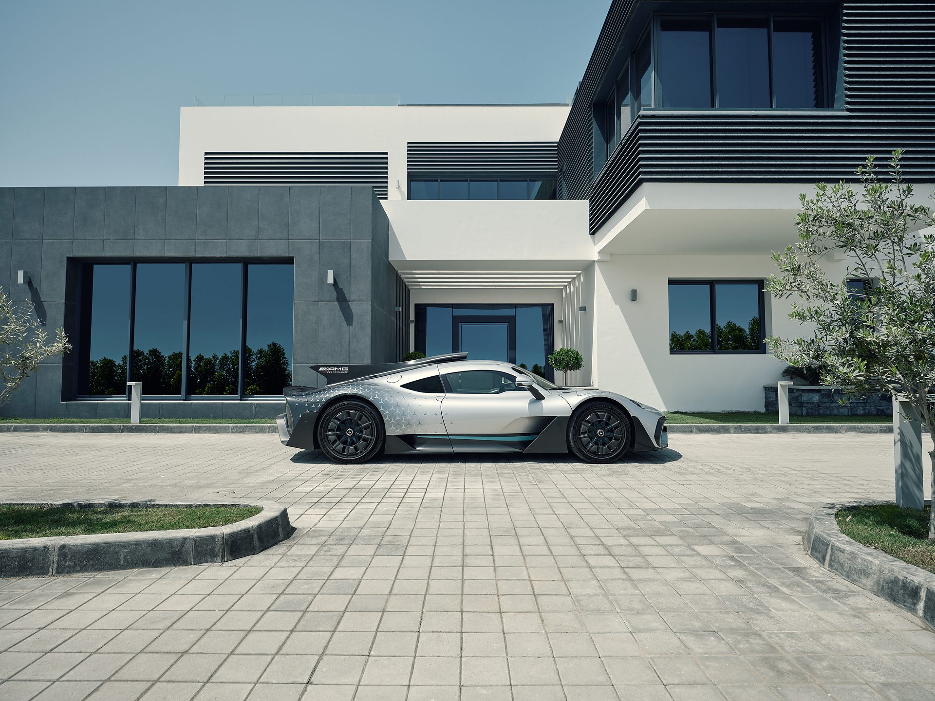 Mercedes-AMG ONE silver side profile with architecture background